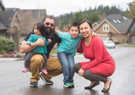 An indigenious family with a child and a baby